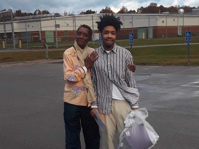 Two customers standing in a parking lot.